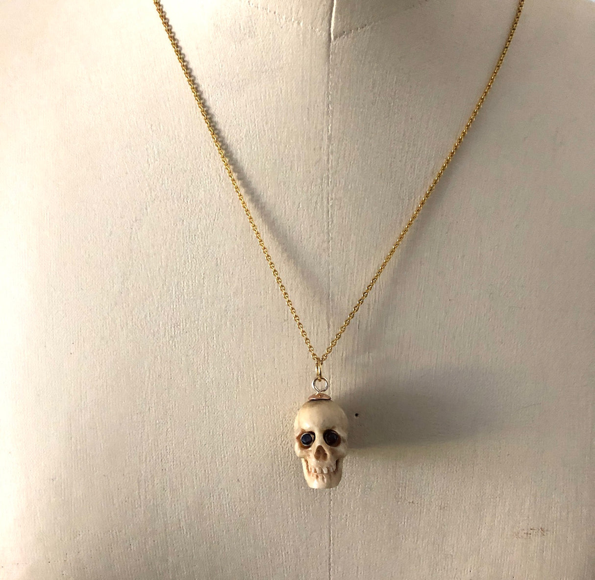 Victorian Carved Bone Skull Pendant with Garnet Eyes The Vintage Jewellery Company